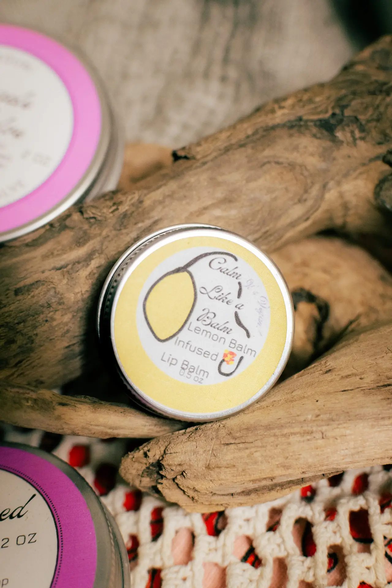 calm like a balm lip balm on driftwood